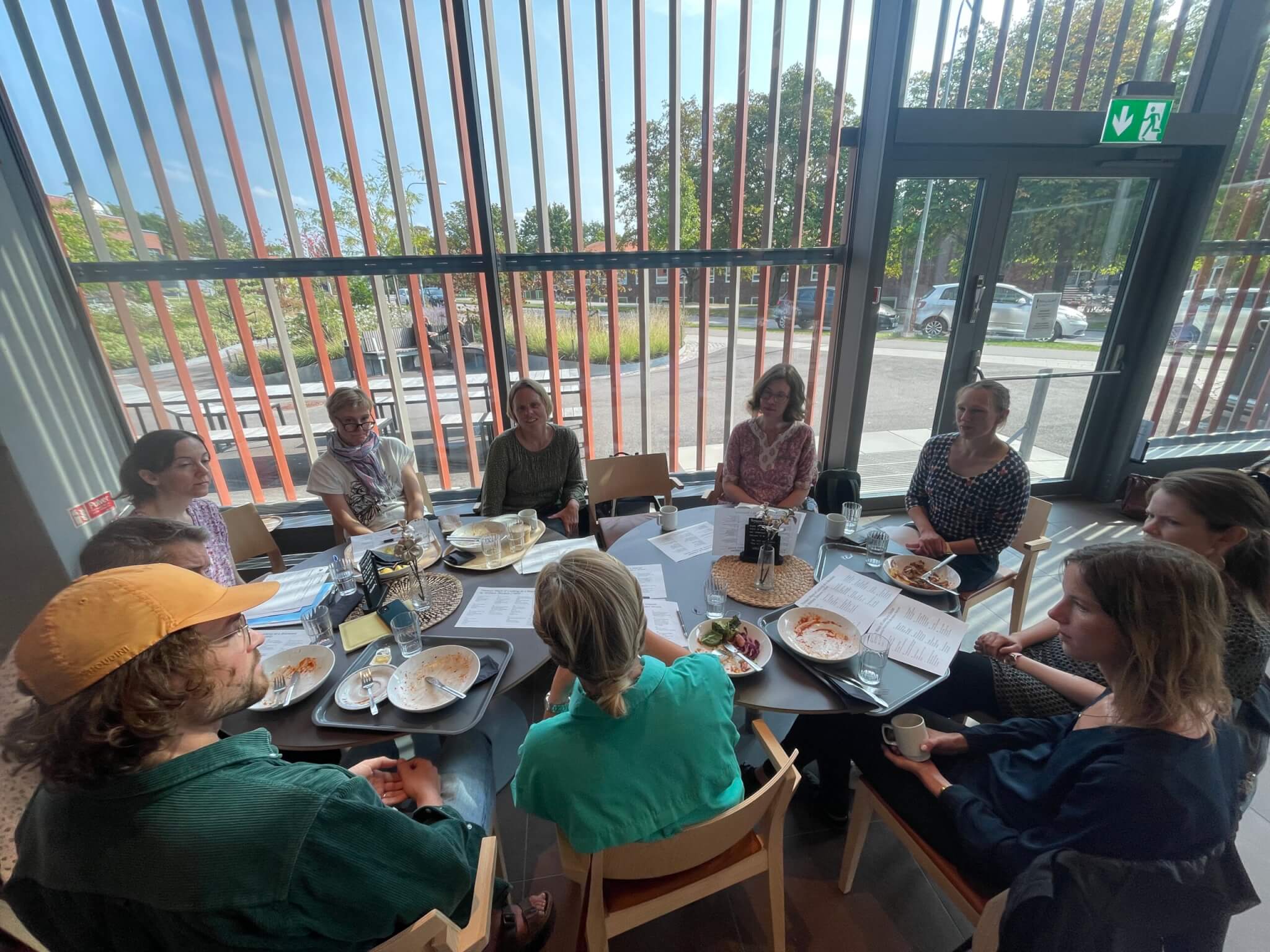 A group of teachers meeting around a lunch table to discuss poetry